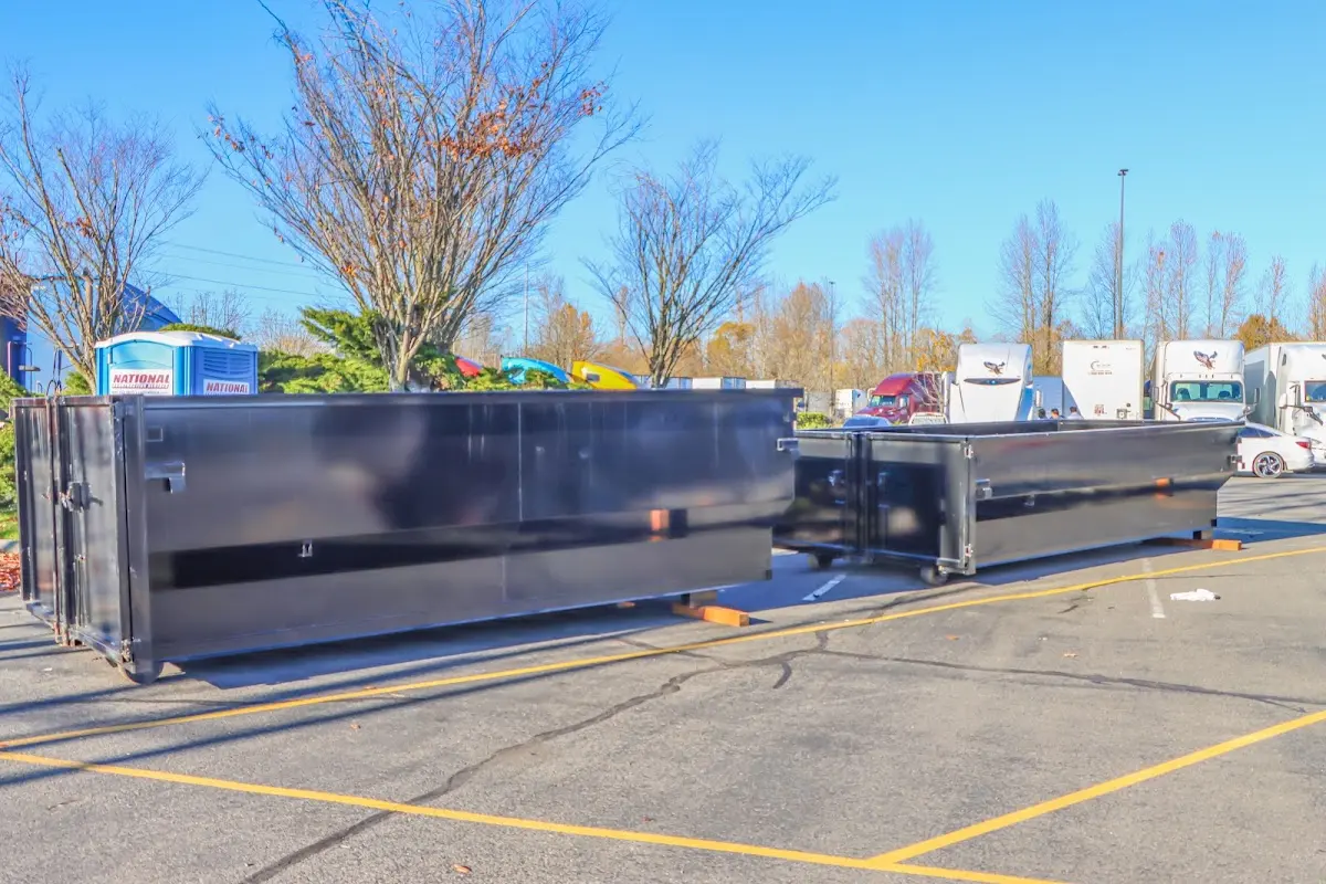 Professional dumpster rental service with roll-off container on residential driveway in Puyallup